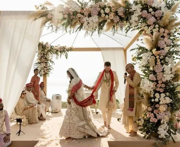 A beautiful boho-chic mandap for a sun-drenched outdoor wedding, featuring pampas grass and pastel roses.
