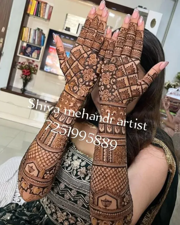 A classic full-sleeve mehendi filled with a dense checkerboard pattern and floral bands. This design offers a timeless and intricate look.
