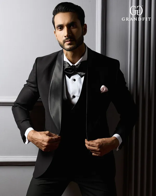 We present the definitive black-tie ensemble. This bespoke tuxedo is crafted with a dramatic shawl lapel and tailored to create a powerful, confident silhouette, ensuring you command attention at any formal event.