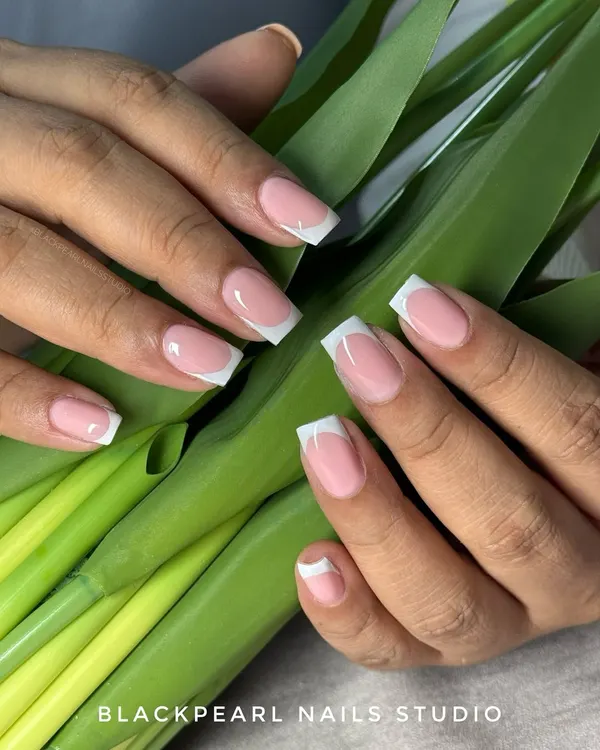 The perfect classic French manicure. This set features a clean, square shape with a sheer pink base and crisp white tips, created using gel extensions for a durable and flawless finish.