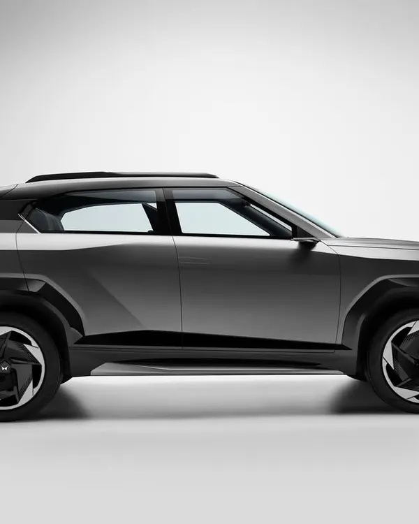 A full profile shot of the Mahindra Vision concept car. This minimalist composition against a clean background emphasizes the vehicle's futuristic silhouette and design language.