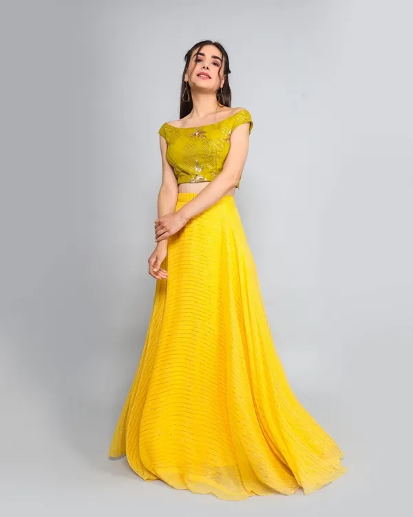 A full-length shot of a model in a vibrant yellow lehenga. I capture movement and flow in ethnic wear to showcase the garment's drape and design, perfect for festive collection lookbooks.