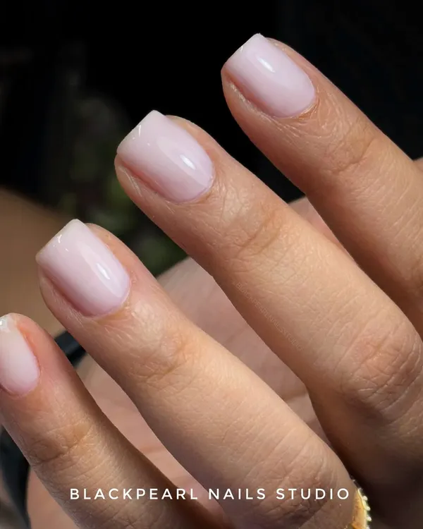 This is the trending "Soap Nails" look, part of the clean girl aesthetic. Achieved with a sheer, milky pink BIAB gel, these nails are minimal, glossy, and have a fresh, ultra-clean appearance.