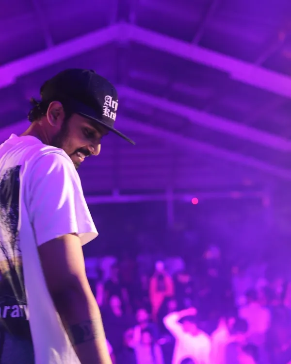 A moment of calm before the drop. This shot captures the atmosphere I love to create, with dramatic lighting and a crowd that's fully engaged with the music. This is what I bring to parties in Coimbatore, Chennai, and beyond.