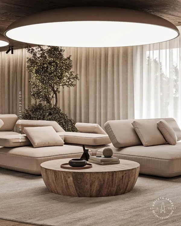 This living room features a large, circular stretch fabric ceiling light that mimics a natural skylight. It provides soft, even, and glare-free illumination that fills the entire space with a bright and airy feel.
