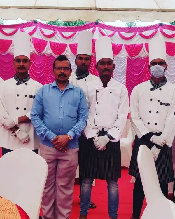 Me and my uniformed team of chefs, ready for service at an event. We prioritize professionalism and teamwork.