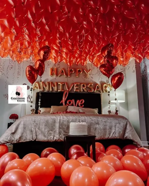 This is the ultimate romantic gesture: a room filled with red balloons. For this anniversary surprise, I covered the ceiling and floor with balloons and added 'Happy Anniversary' and 'Love' foil letters above the bed for a truly immersive experience.