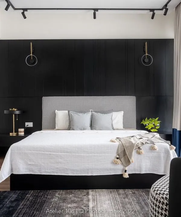 Go bold or go home. We absolutely love how this master bedroom turned out, with a dramatic black paneled wall creating a sophisticated and moody backdrop for the soft, light-colored bed and furnishings.
