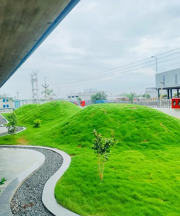 The rolling grass mounds at this commercial building are a perfect example of modern landscape architecture. This design is not only visually striking but also low-maintenance, making it ideal for a corporate environment.