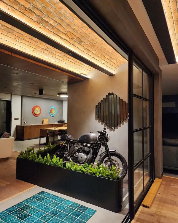 We created this custom living partition for a stylish home in Hyderabad. The clients, both bikers, wanted to feature their Triumph motorcycle as a design element while keeping it safely separated from their toddler's play area. This is what we do best: creating green solutions that are both beautiful and functional.