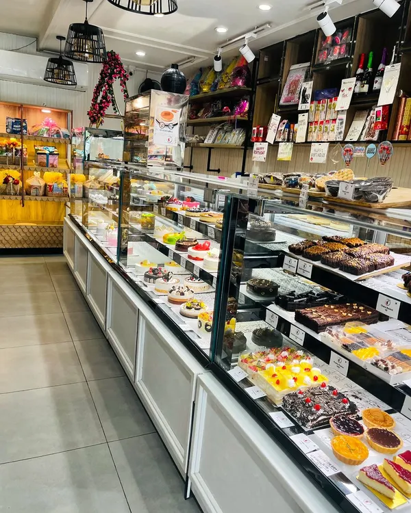 A look inside our bakery, with long display cases filled with a huge variety of freshly baked cakes, pastries, brownies, and more. There's something for everyone.