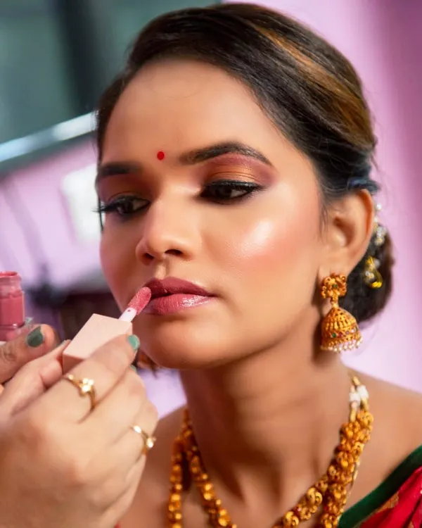 A glimpse of my process. Here, I'm applying a soft, glossy lip color to complete this dreamy, glowing makeup look.
