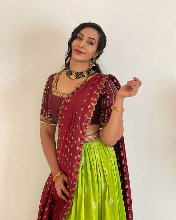 This lime green and maroon half saree is one of my most loved designs. The contrast is so eye-catching, and the hand-embroidered blouse adds a touch of elegance. It’s a perfect outfit for any festive occasion.