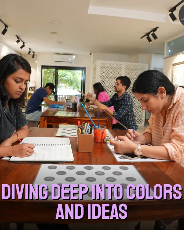 My studio is a place for diving deep into colors and ideas. Here, a group of adult learners are fully engaged in their individual projects, from sketching to painting, in a calm and creative environment.