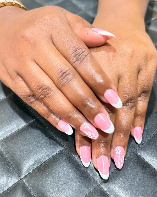 The classic French manicure is always in style. Here, I've created a clean look on almond-shaped nails with a delicate floral accent for a touch of personality.