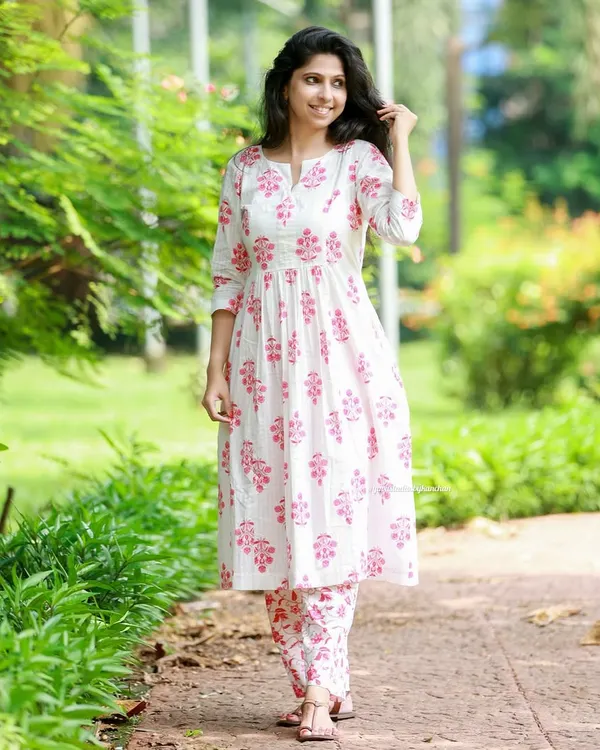 Elevate your style with this elegant white and pink printed kurta pant set. Made from pure cotton, the kurta has two pockets and can also be worn as a one piece dress.