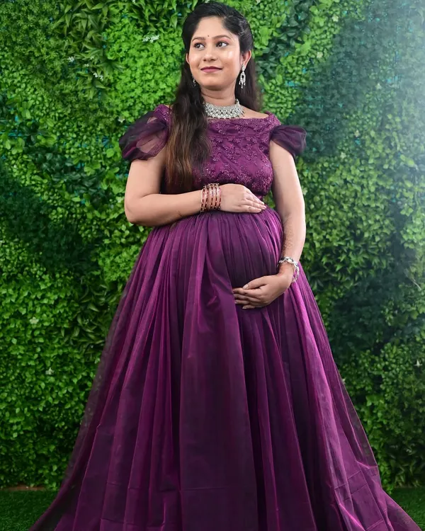 A beautiful mom-to-be glowing in our purple off-shoulder maternity gown. This style is very popular for both indoor and outdoor photoshoots.