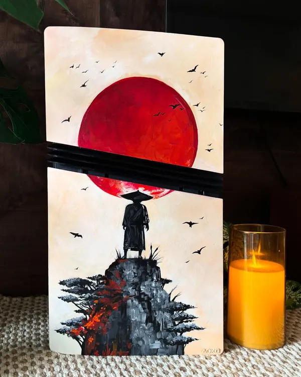 A custom PS5 console inspired by the beautiful and atmospheric game, 'Ghost of Tsushima'. The silhouette of the samurai against the red sun is such a powerful image.
