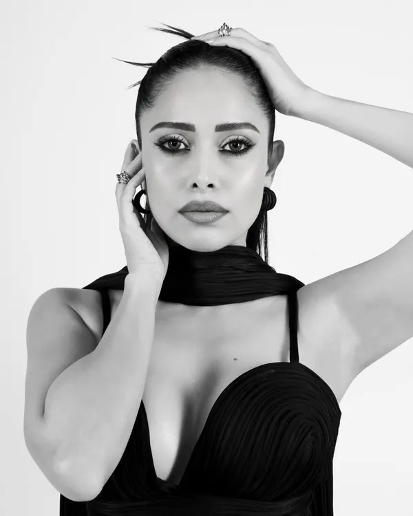 A stunning black and white close-up of Nushrratt Bharuccha. The high-contrast lighting and sharp focus on her eyes create a powerful and intimate portrait.