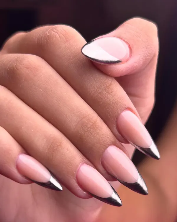 Sleek, sharp, and impossibly chic. This chrome-tipped French manicure on a long stiletto nail is the definition of modern elegance.
