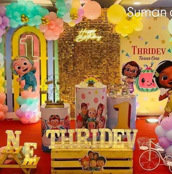I created this complete Cocomelon themed first birthday party setup, featuring a custom backdrop, character cutouts, a multi-colored balloon arch, and personalized name blocks. This is a great example of a full-package event decoration.