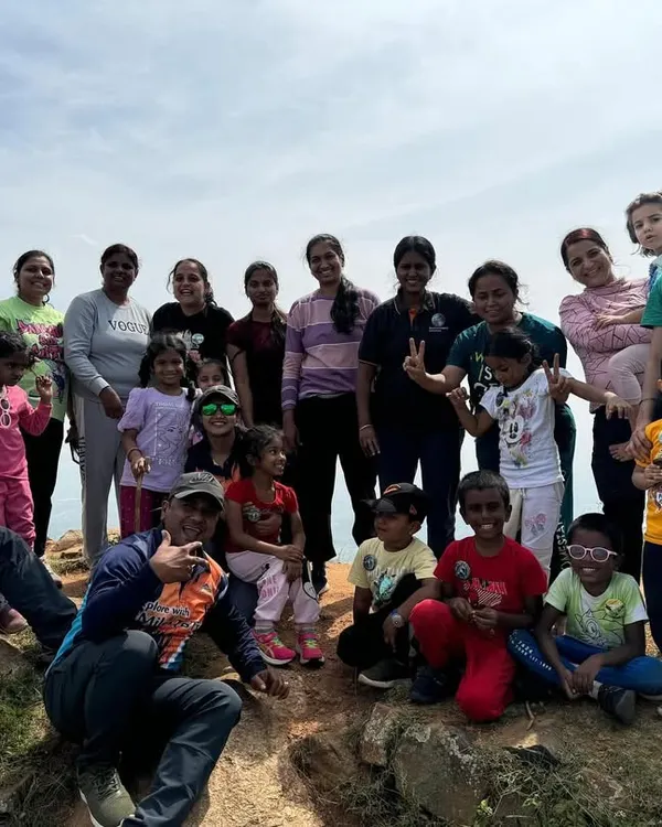 A large group of mothers and their children posing together on a mountaintop. Our 'Mom & Me' treks are a wonderful way for families to connect with nature and each other.