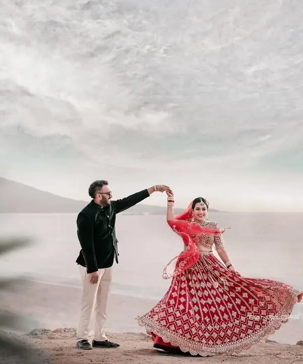 I believe in capturing the movement and joy in your love story. Here, against a vast, open seascape, her twirling lehenga and their shared laughter create a moment of pure, unscripted bliss. This is the kind of epic, yet personal, memory I strive to create.