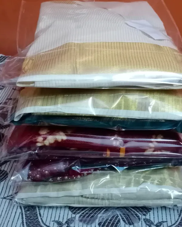 A stack of sarees, all pleated, finished, and packed for my clients. This is how your sarees will be delivered, ready to store or travel with.