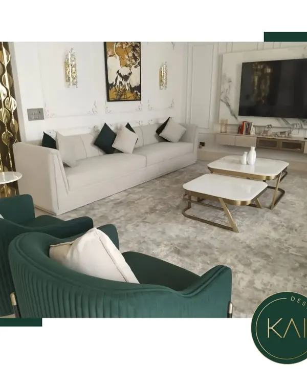 We designed this living space to be a sanctuary of modern elegance. The arrangement features a plush off-white sofa, complemented by deep green, channel-tufted accent chairs and dual marble-topped coffee tables, creating a sophisticated environment for relaxation and social gatherings.