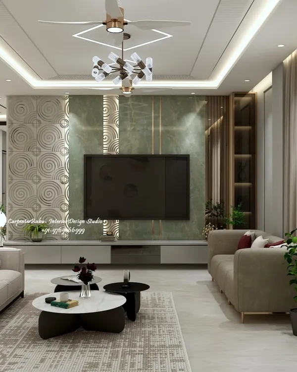This living room features a striking TV wall that combines a rich green marble-finish panel with a 3D textured element. The design balances bold materials with the warmth of the surrounding neutral tones and cove lighting, creating a sophisticated entertainment zone.