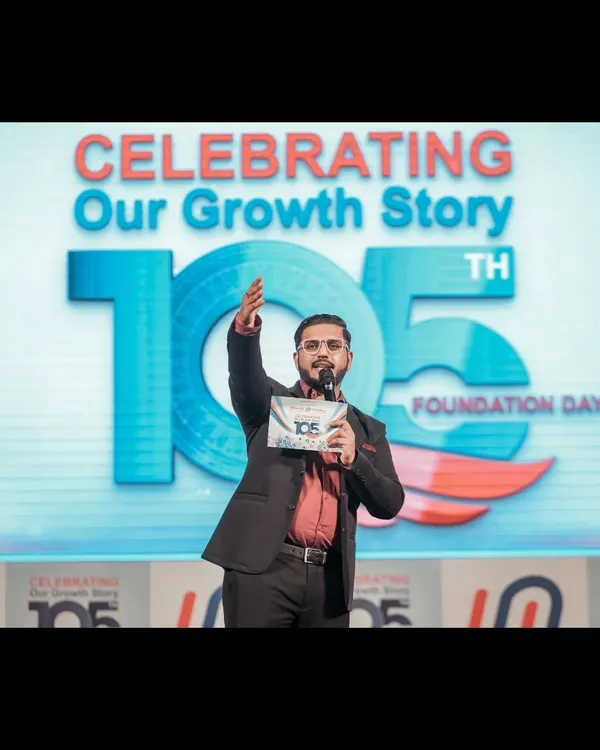 On stage, commanding the room during a corporate foundation day celebration. My focus is always on creating a dynamic atmosphere that celebrates the company's growth story.