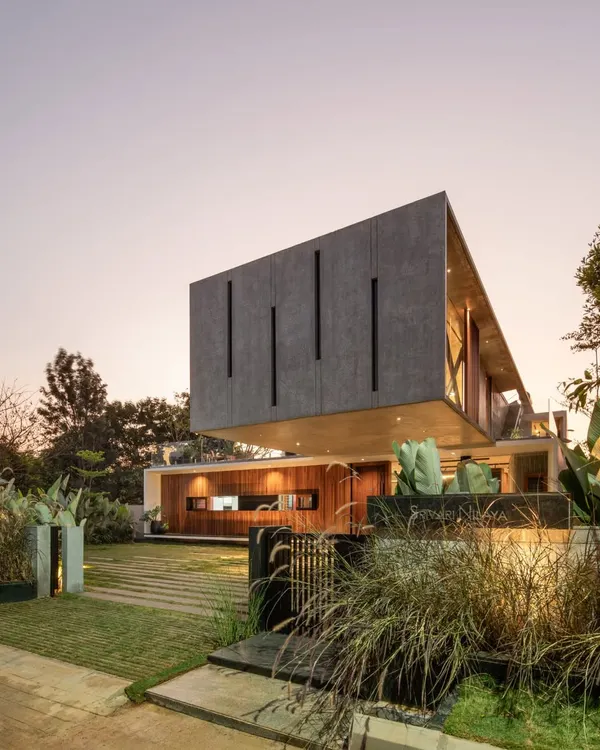 This is the Long House, a design defined by a dramatic cantilevered volume that appears to float above the landscape. We used exposed concrete and warm timber to create a structure that is both monumental and deeply connected to the earth, embodying our approach to tropical modernism.