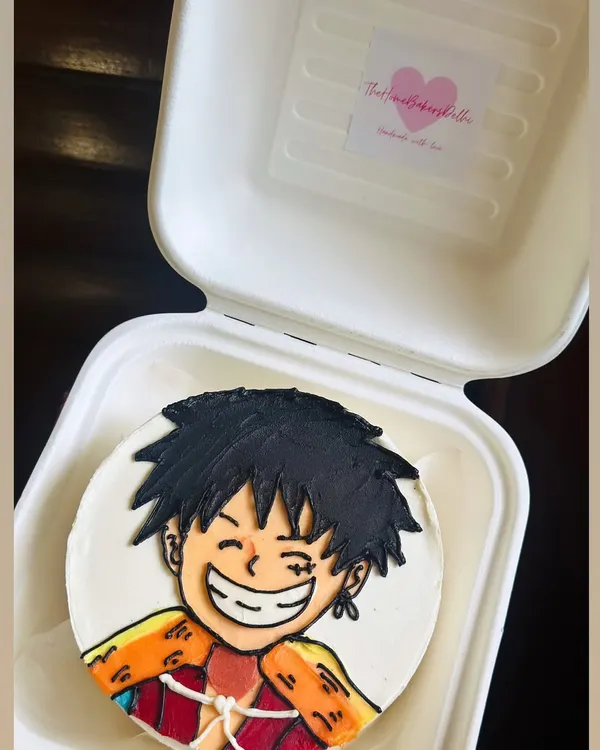 A fantastic buttercream illustration of an anime character on a bento cake. We love the challenge of capturing the energy and expression of these characters by hand.