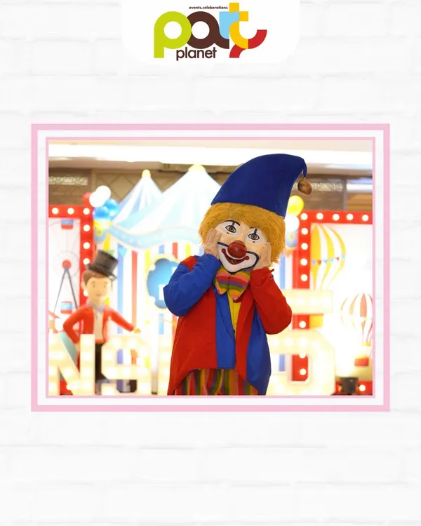 A friendly clown mascot at a circus-themed party, ready to entertain guests and bring smiles to everyone's faces.