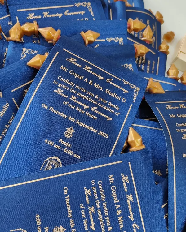 A pile of royal blue satin scroll invitations, each tied and ready to be sent out, showcasing a unique and memorable way to invite guests.