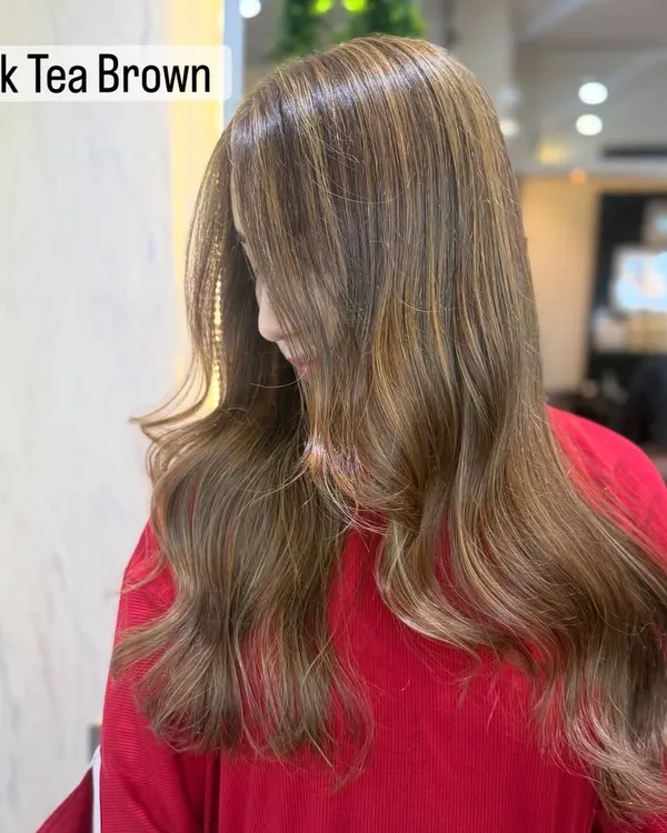 A beautiful example of a soft, illuminated bronde in a shade we call Milk Tea Brown. It's the perfect mix of brown and blonde.