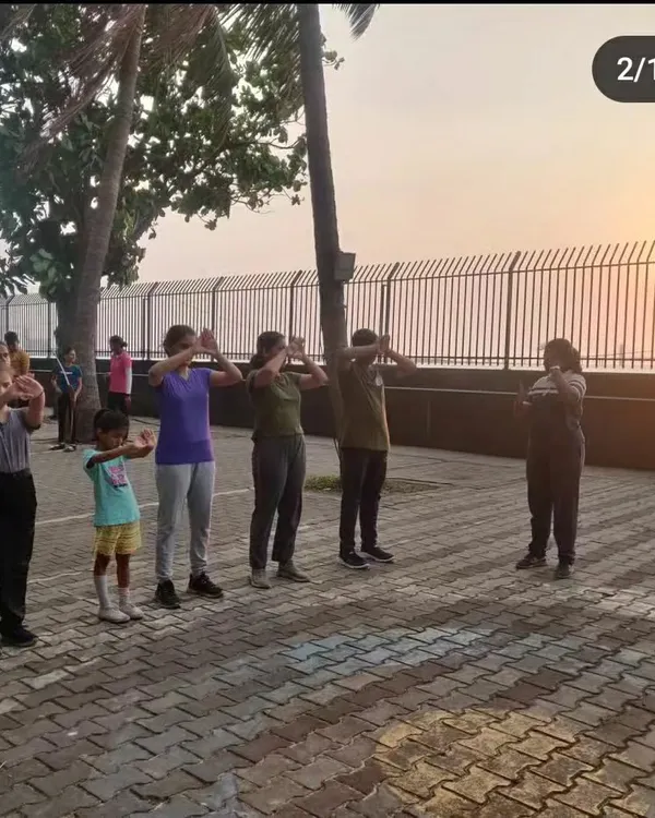Every session begins with proper warm-ups and stance practice. Here, a group of students learns the correct body alignment before even picking up a bow, ensuring a solid foundation for safety and accuracy.