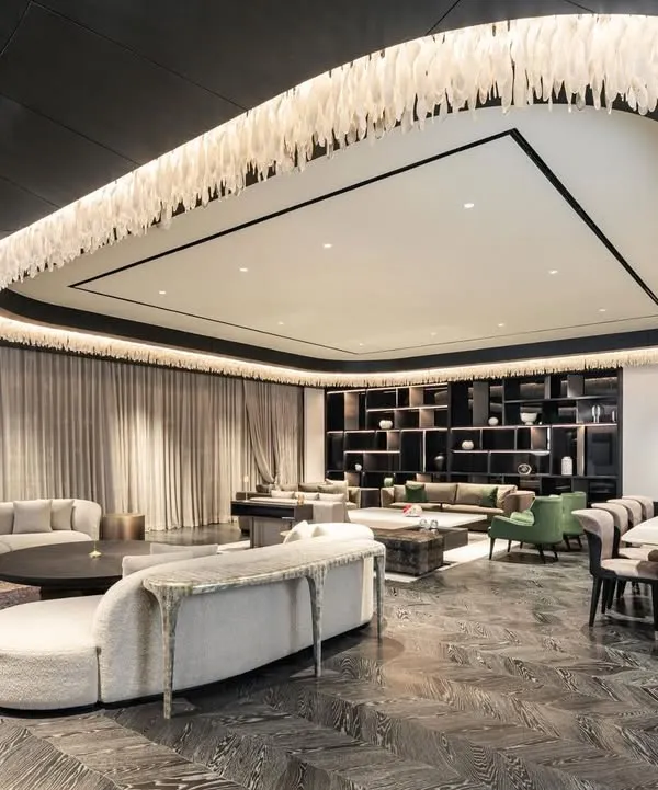We believe a home should be a sanctuary of calm and elegance. In this expansive Gurugram residence, we designed a living area where scale and intimacy coexist. A custom glass shard light installation floats beneath a dark wood canopy, defining the space while custom-designed curved sofas and seating arrangements encourage conversation and flow.