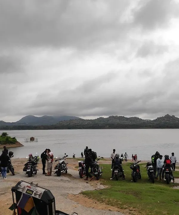Our riders and their bikes parked by the serene Mydala Kare Lake during a breakfast ride. These rides are as much about the destination and the conversations as they are about the journey.