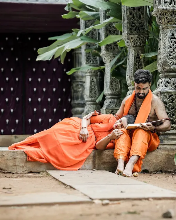 The central portrait from our Ram and Seetha themed maternity shoot. The expecting mother rests peacefully as her partner reads, set against ornate, traditional Indian architecture.
