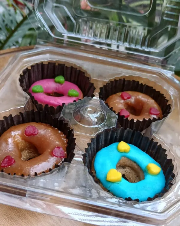 Look at these colorful, freshly baked donuts! I make these with pet-safe icing and natural ingredients like apple, pumpkin, and peanut butter. They are a perfect little treat to make any day feel like a celebration.