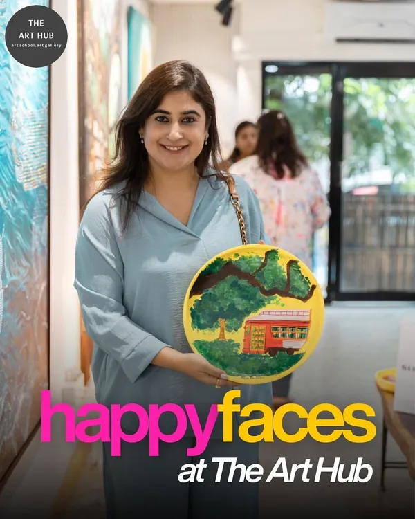 A happy participant proudly presents the vibrant plate she painted. Everyone leaves our workshops with a finished piece of art, a tangible reminder of their creative achievement and a fun day with their team.