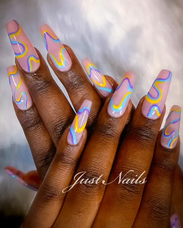 A true work of art on extra-long coffin nails. This design features a mesmerizing, multi-colored wavy pattern that showcases my passion for creating unique, custom looks.