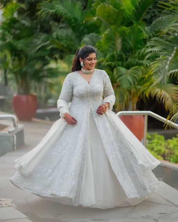 For the Sangeet, comfort is key for a night of dancing. We chose this gorgeous ivory jacket-style lehenga with intricate zardozi work. The flowing organza skirt is lightweight and perfect for twirling on the dance floor.