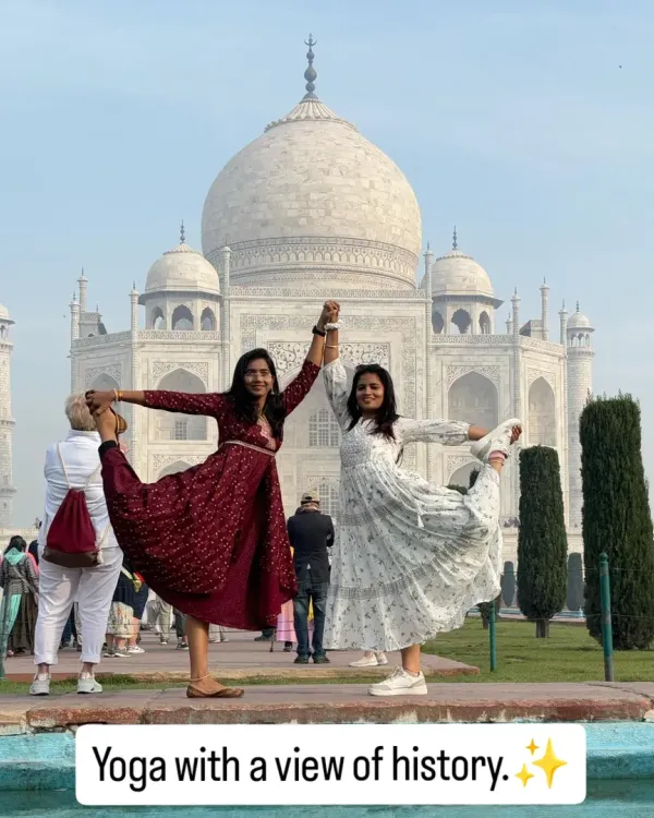 Yoga with a view of history. Practicing Natarajasana (Dancer's Pose) with a friend at the timeless Taj Mahal, a symbol of love and balance.