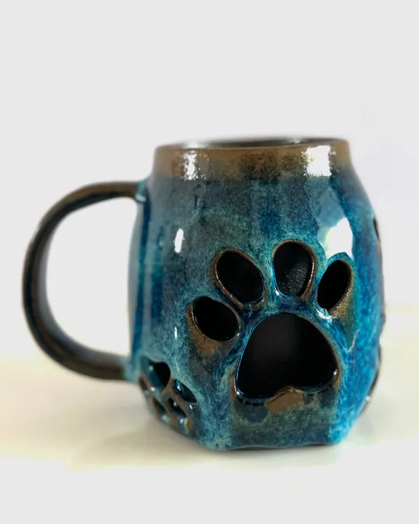 This double-walled paw print mug is one of my favorite designs, perfect for dog lovers. The double-wall construction keeps your drink hot while the outside stays comfortable to hold, and the deep blue glaze gives it a beautiful, rich finish.