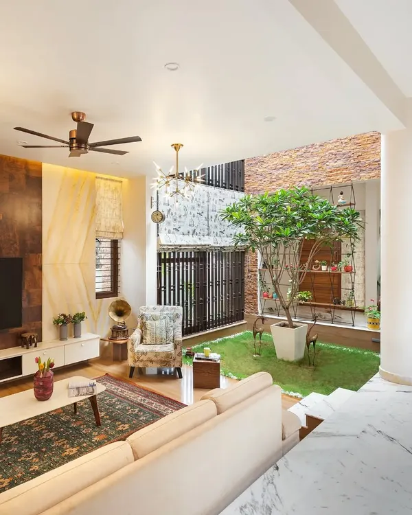 A view of the living room at our Twin Courtyard project, showing how the space is designed around the central green area. This layout ensures the home is always filled with natural light and a sense of openness.