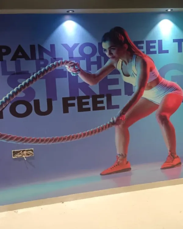 A high-energy fitness mural installed in a gym. The vibrant colors and motivational text are perfect for creating an inspiring workout environment.