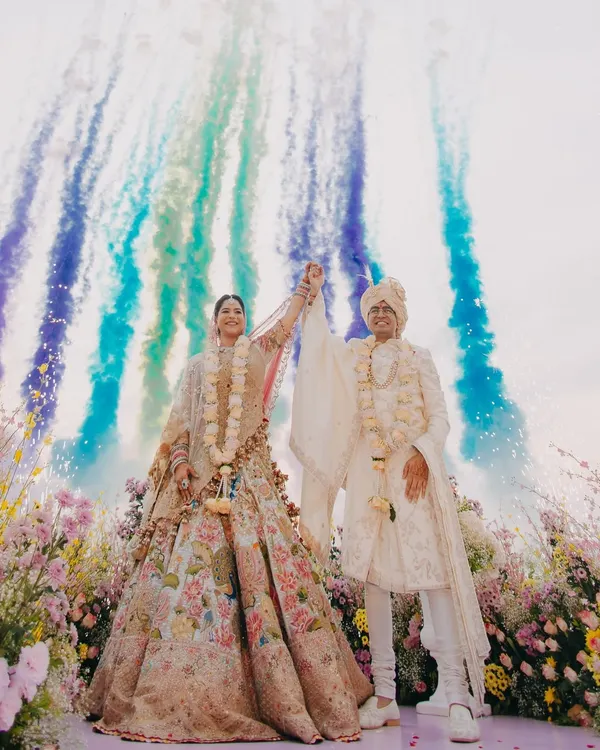 A moment of pure celebration for Vedika and Yuvraj at their Goa wedding. We love using dynamic elements like colored smoke to create vibrant, unforgettable images that capture the energy of the day. This is the kind of grand, joyful shot that feels like a scene from a movie.