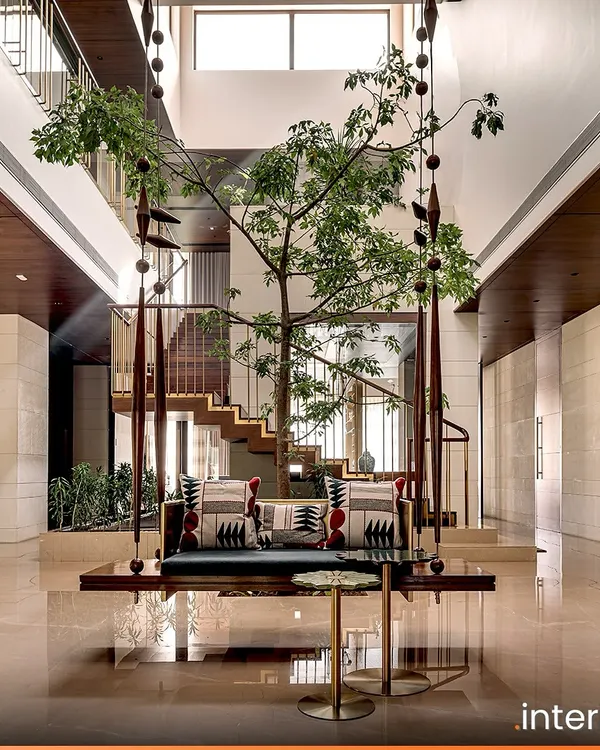The Aangan residence in Ahmedabad reinterprets the traditional Indian courtyard home. This central space features a custom swing under a living tree, creating a tranquil heart for the home that connects the family with nature and heritage.